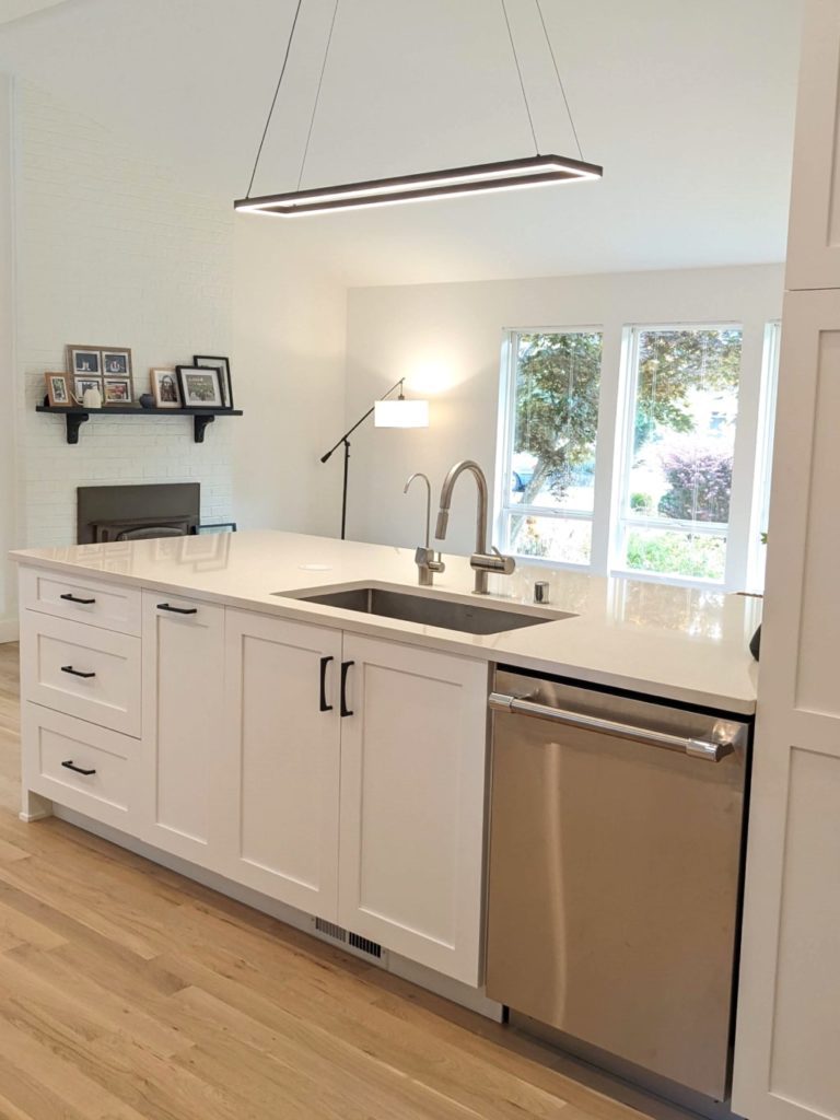 Modern farmhouse kitchen with island peninsula and chandelier LED pendant light